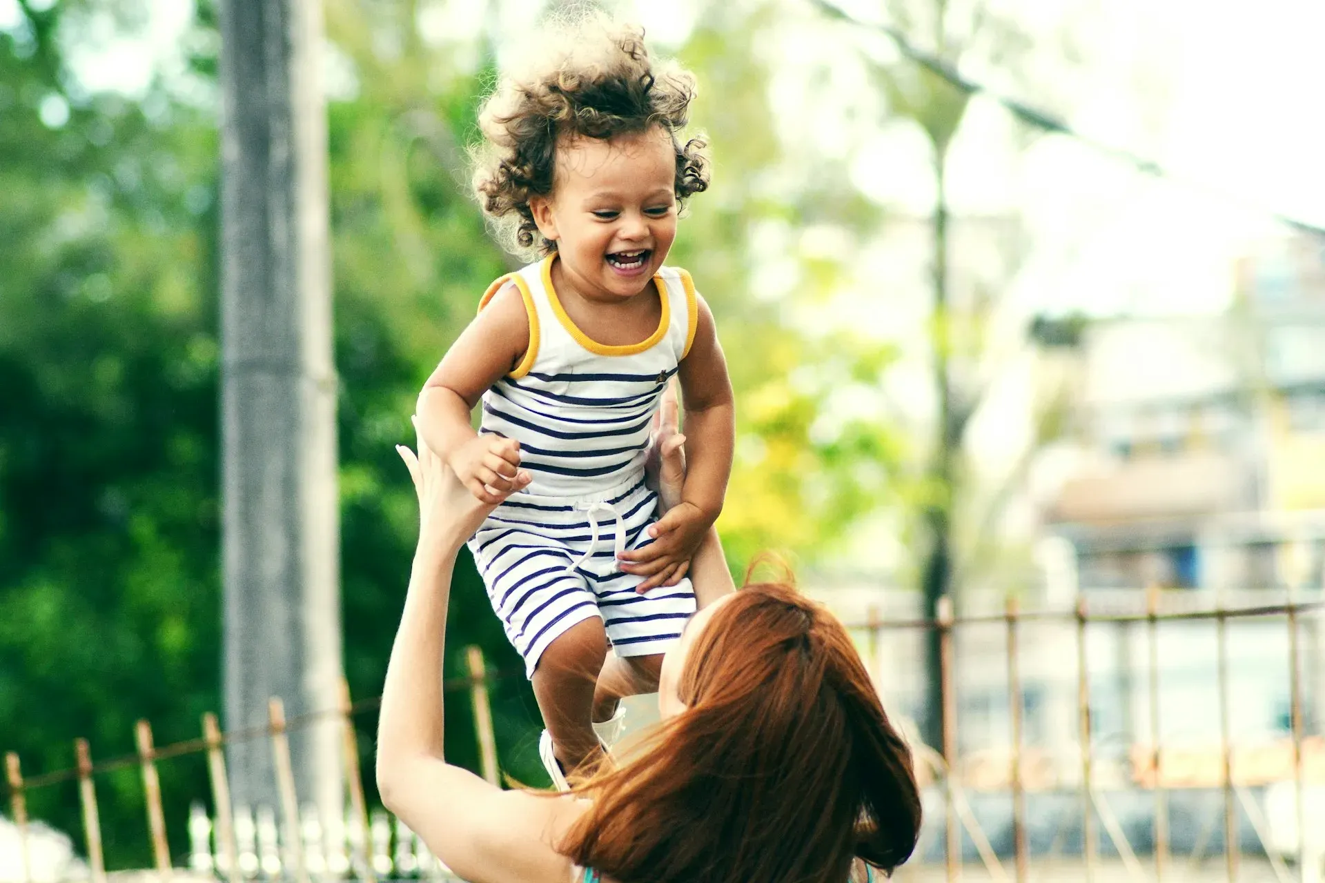 Parent and child laughing together at home