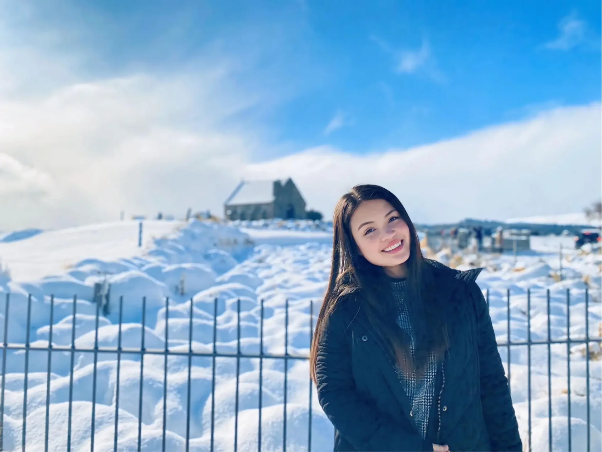 Jeanie, the founder of Jumpstart International, smiling as she poses in front of a snowy landscape in New Zealand.